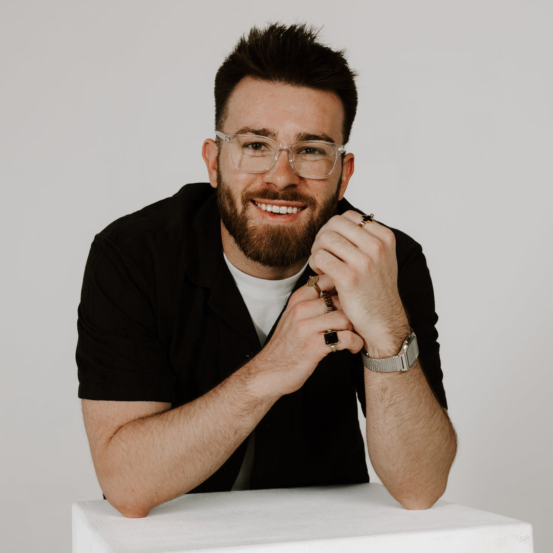 CONQUERing Co-Creator Posing for Headshot wearing fidget jewelry