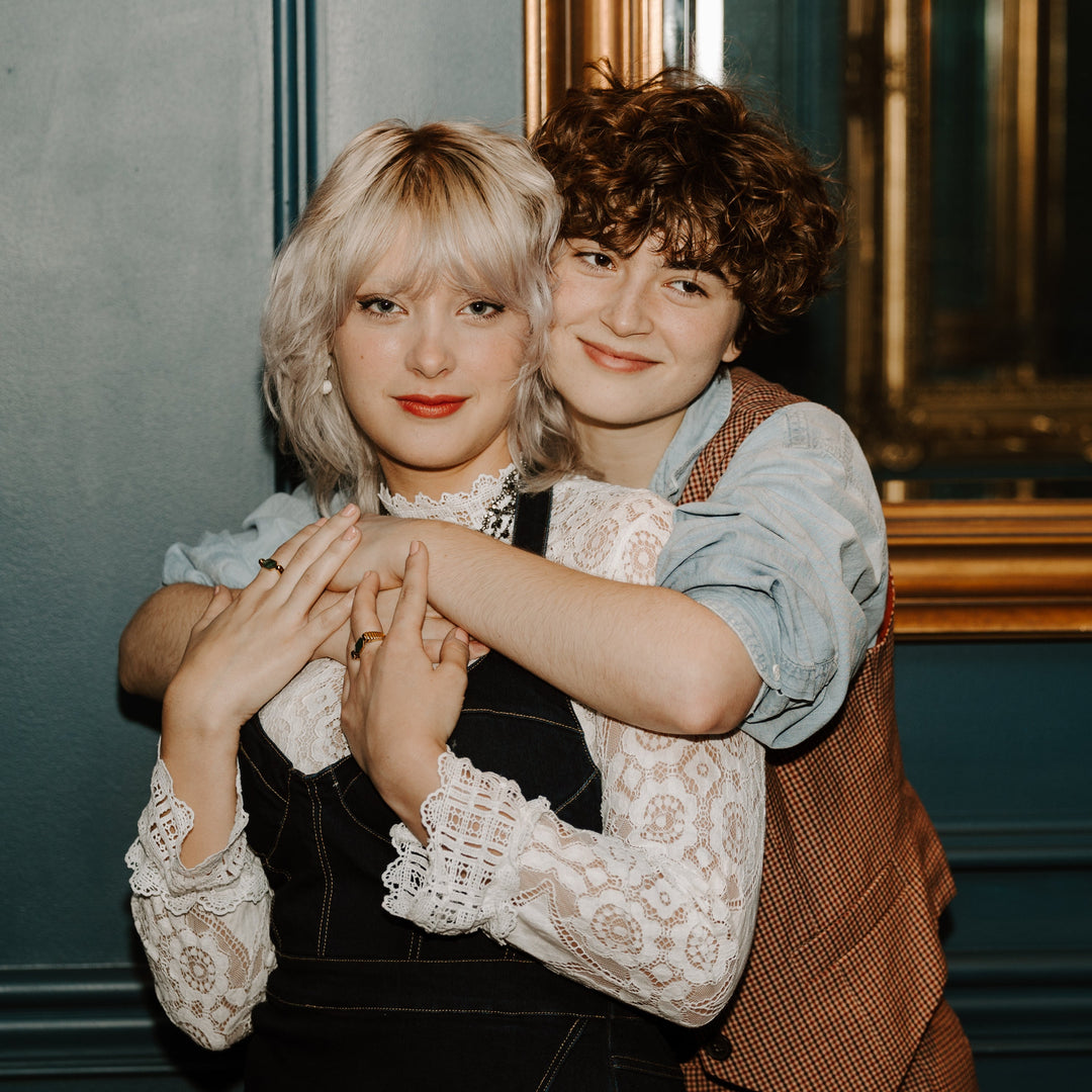 Two people embracing wearing fidget jewelry