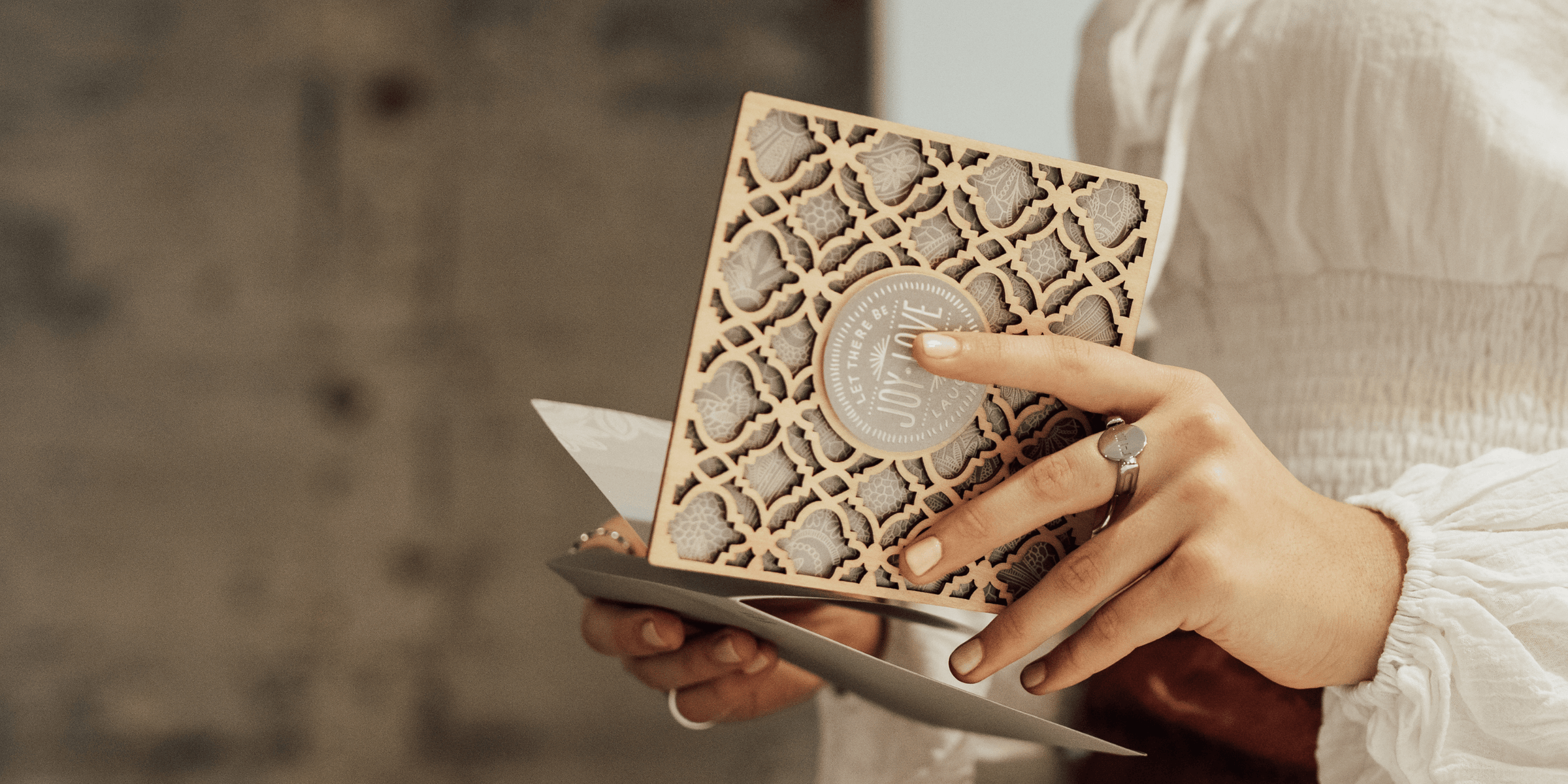 hands holding a greeting card to read it