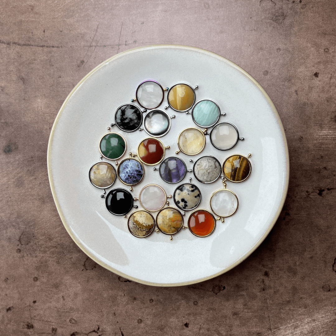 crystal collection spinners in a white dish, on a cement background