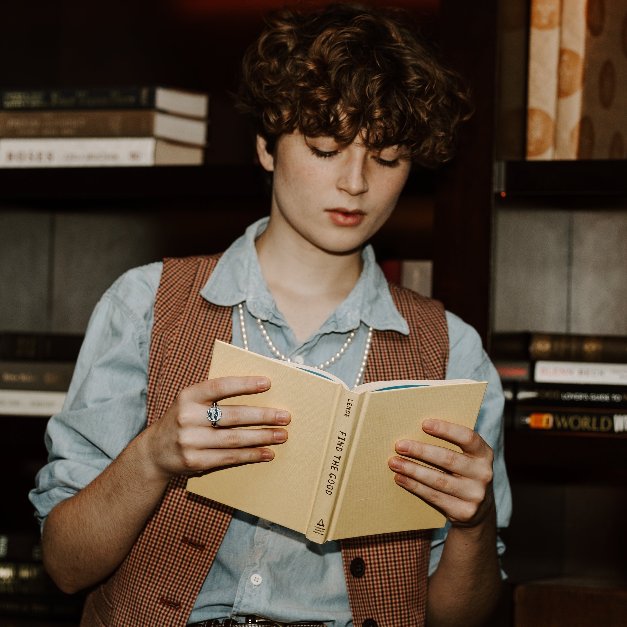 Photograph of person reading a book wearing a fidget ring