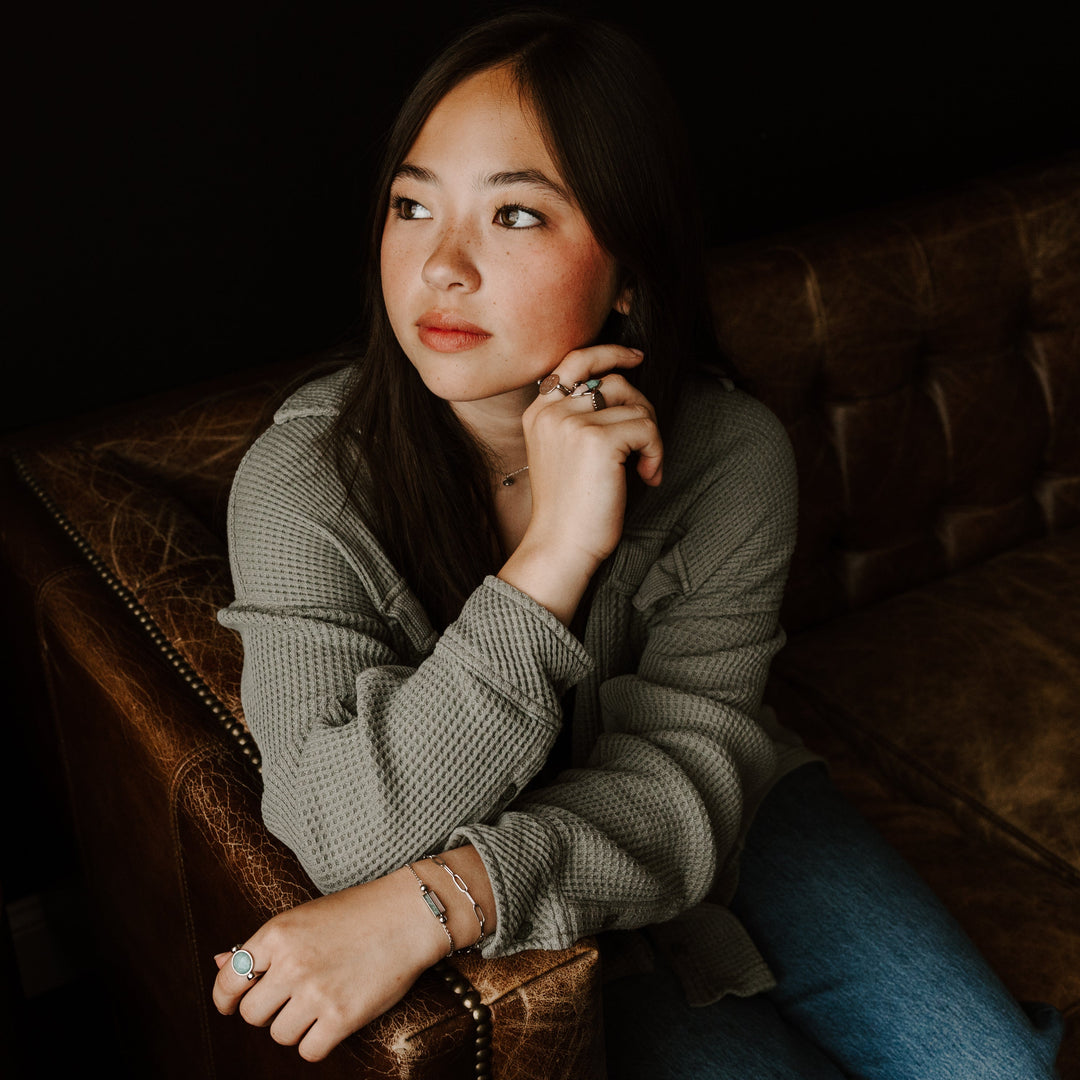 Person sitting on a couch wearing fidget rings