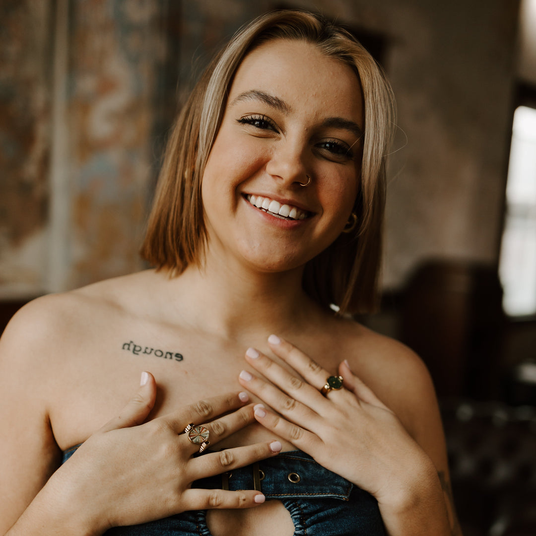 Person smiling and posing wearing fidget rings