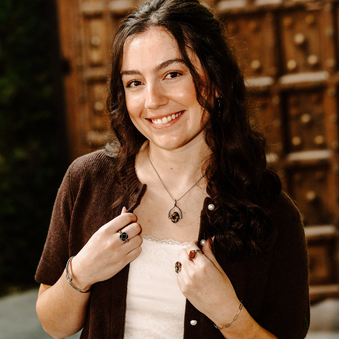 Person posing and showing off their interchangeable jewelry
