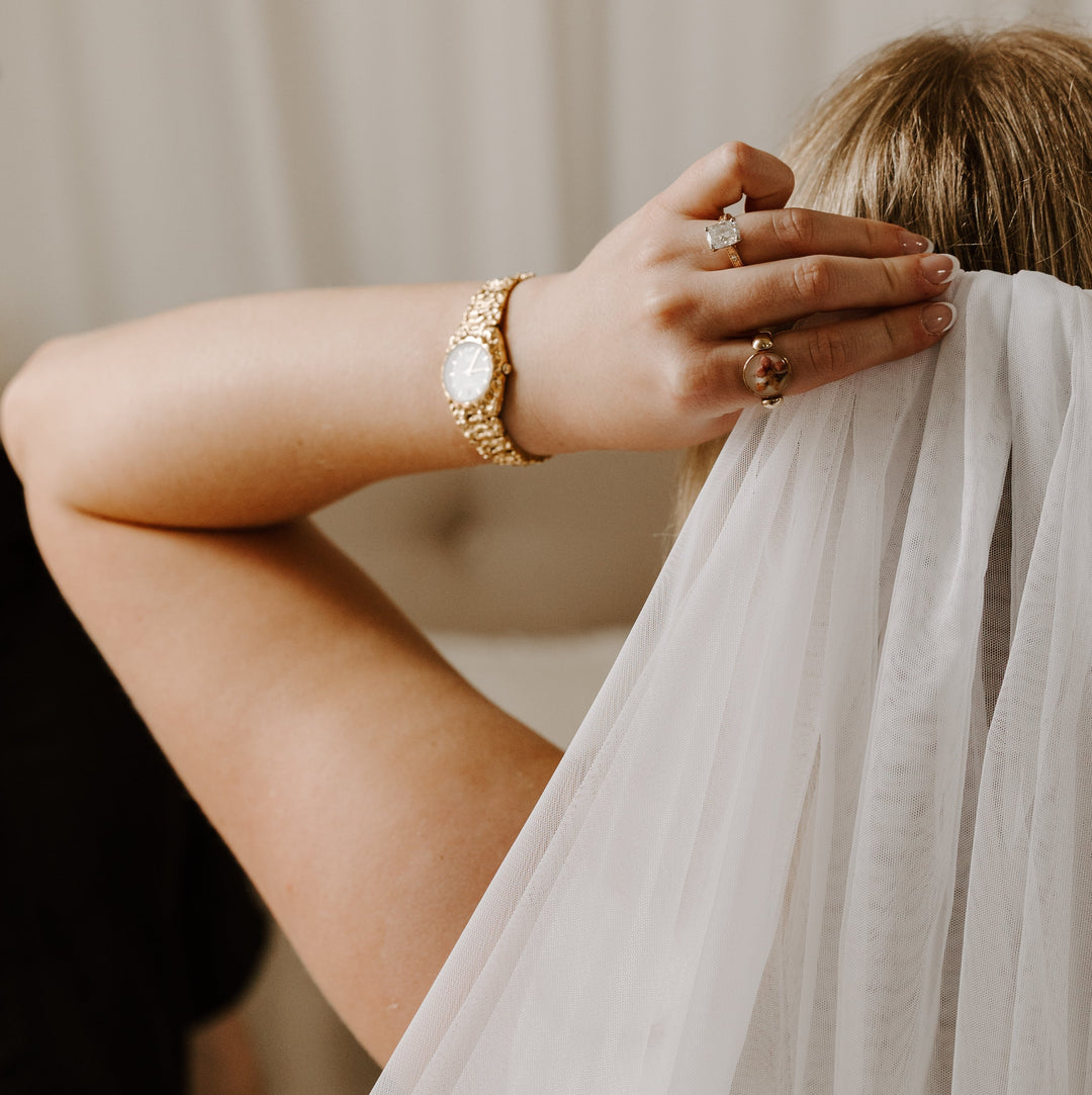 Bride fixing her veil wearing fidget jewelry