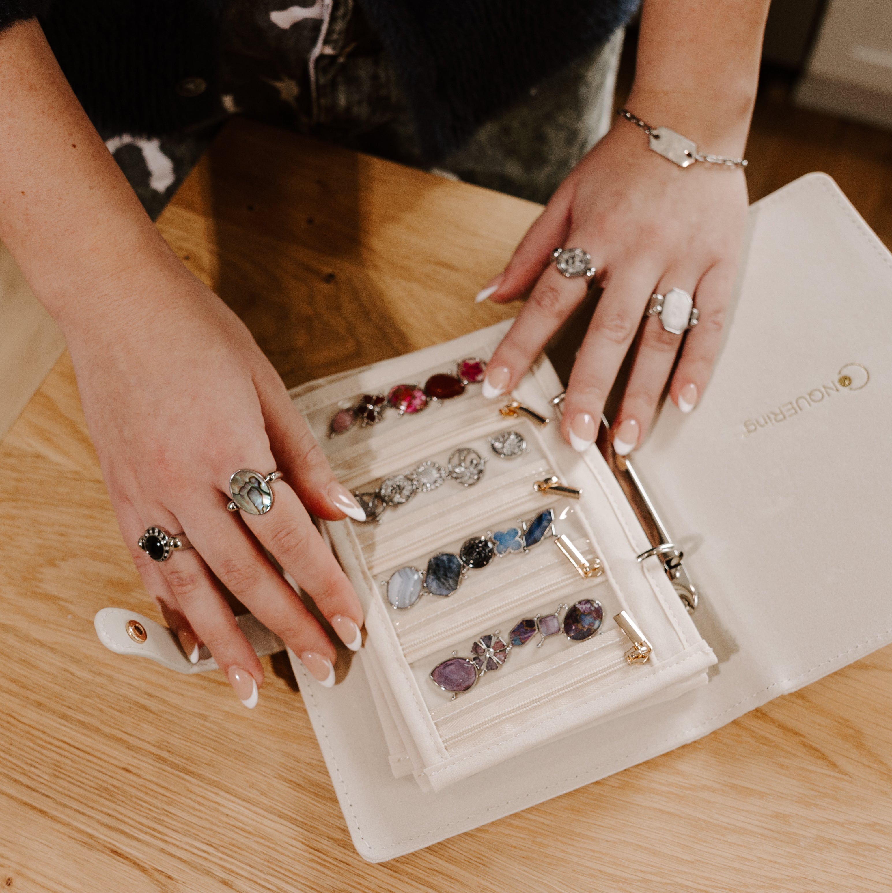Person looking through crystal jewelry to decide what to wear