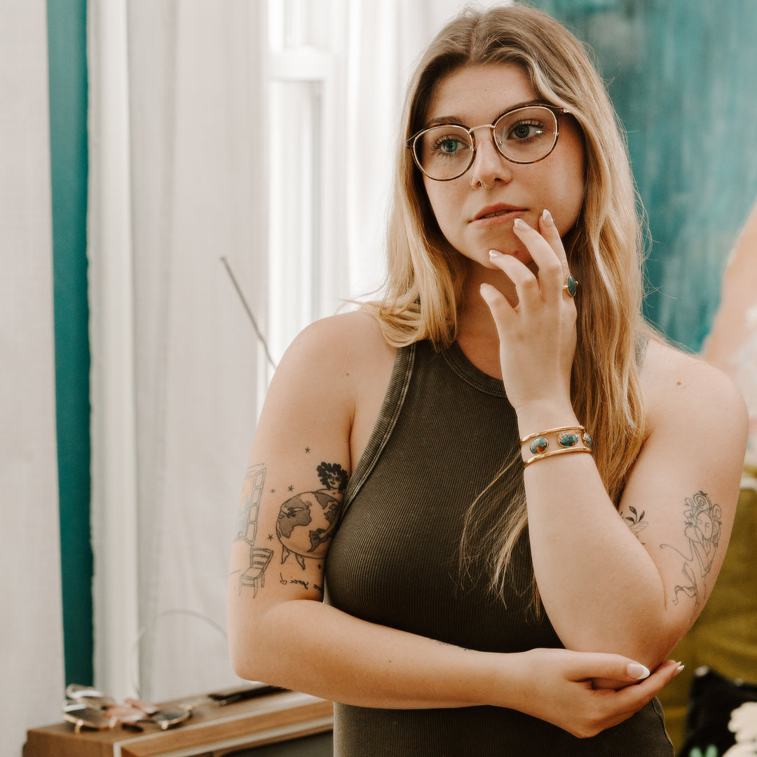 Person looking in a mirror wearing crystal fidget jewelry