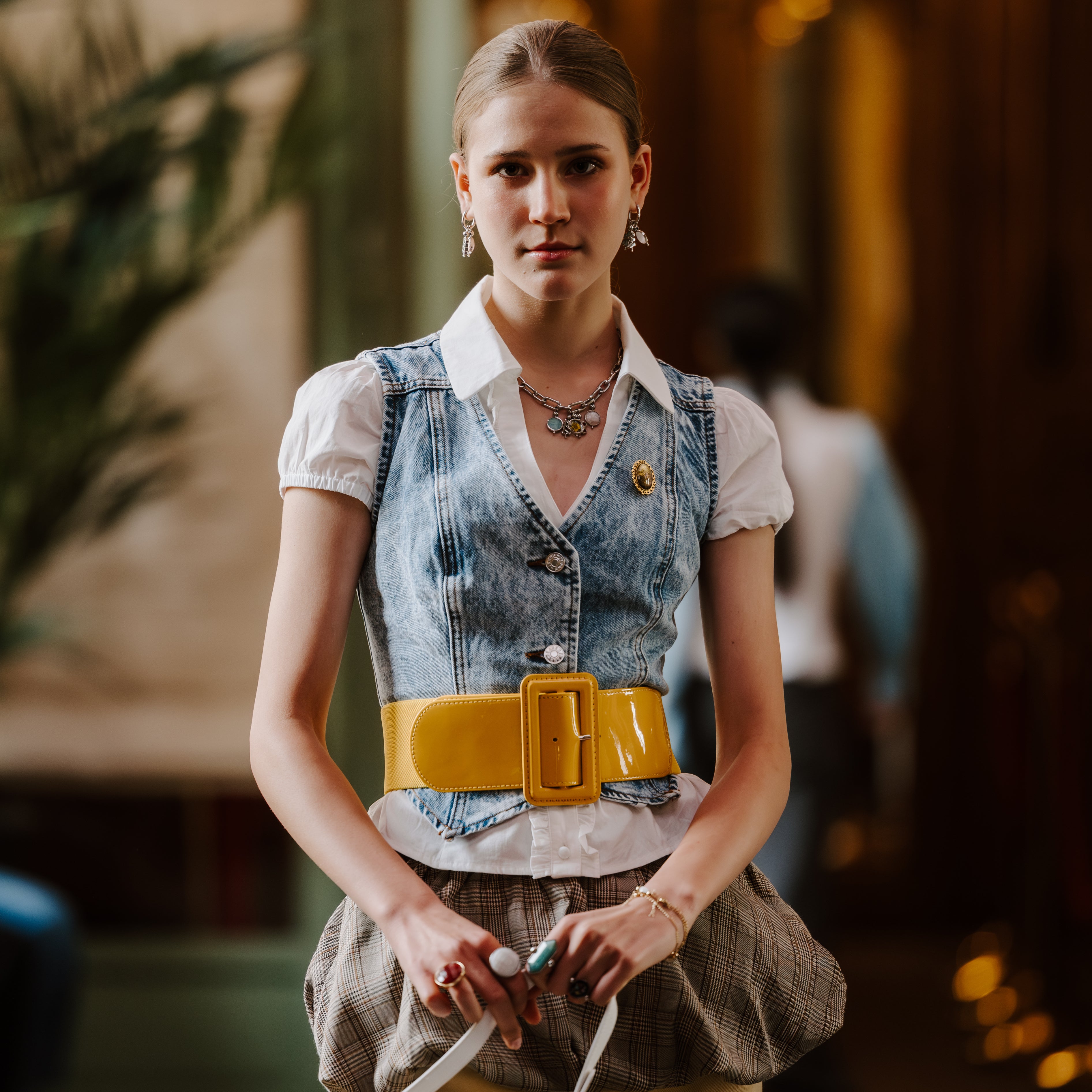 Person posing on a runway wearing trendy fidget jewelry