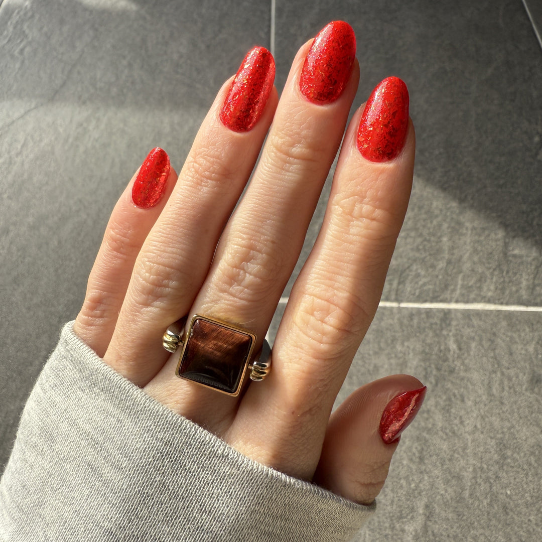 Lifestyle photo of cushion Red Tiger's Eye fidget ring