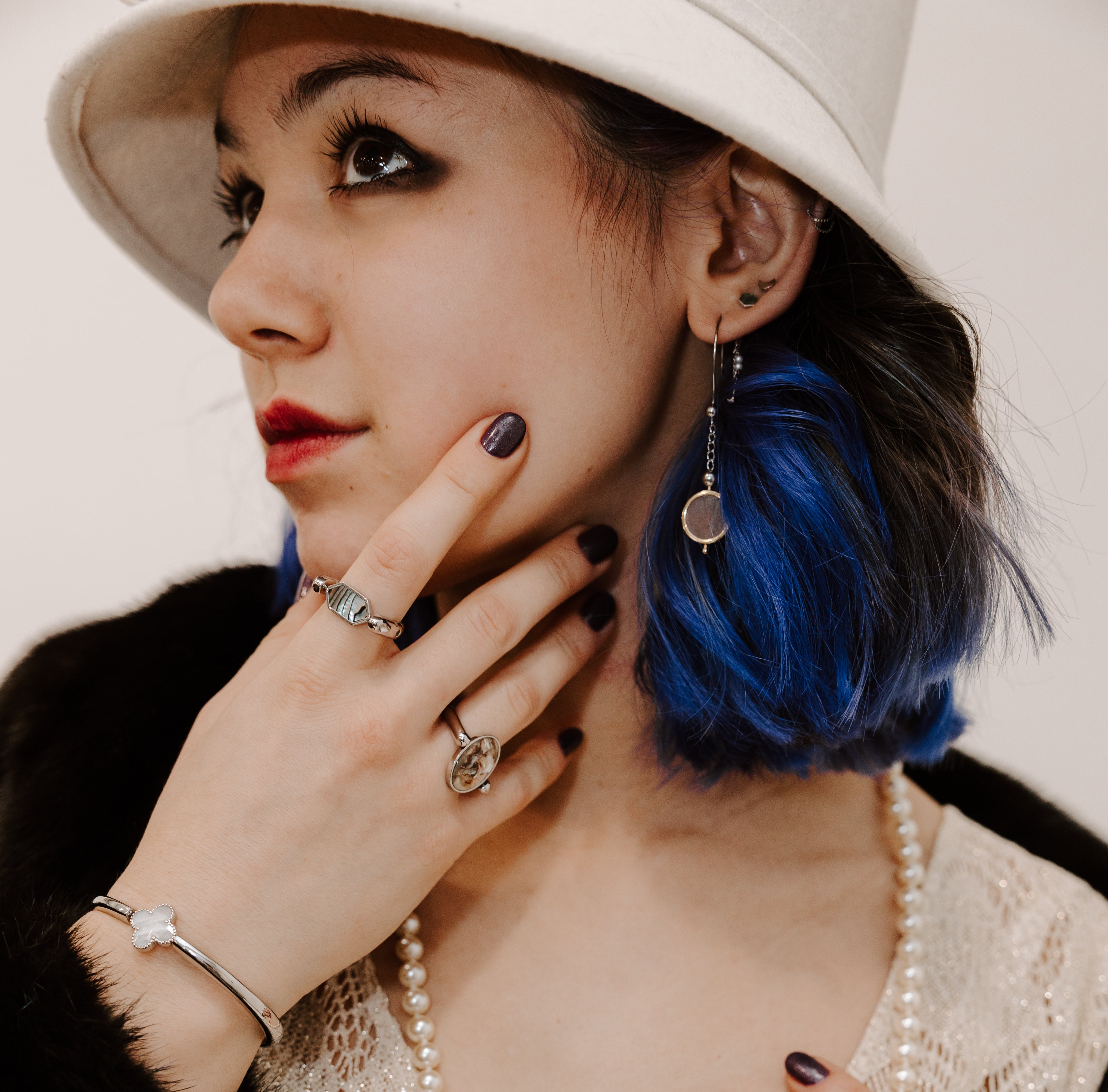 Person modeling for a 1920s photoshoot wearing fidget jewelry