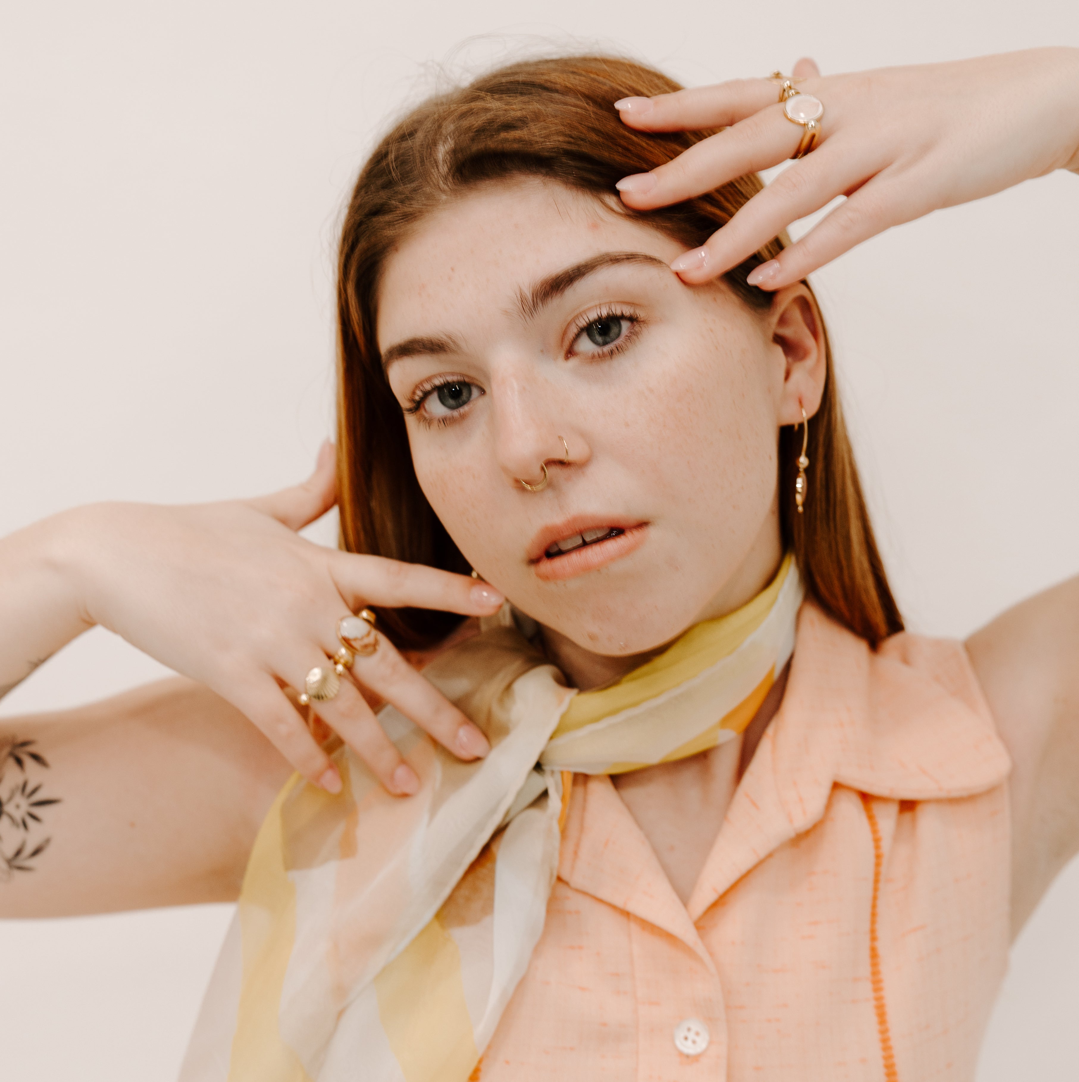 Person posing wearing 1960s clothing and fidget jewelry