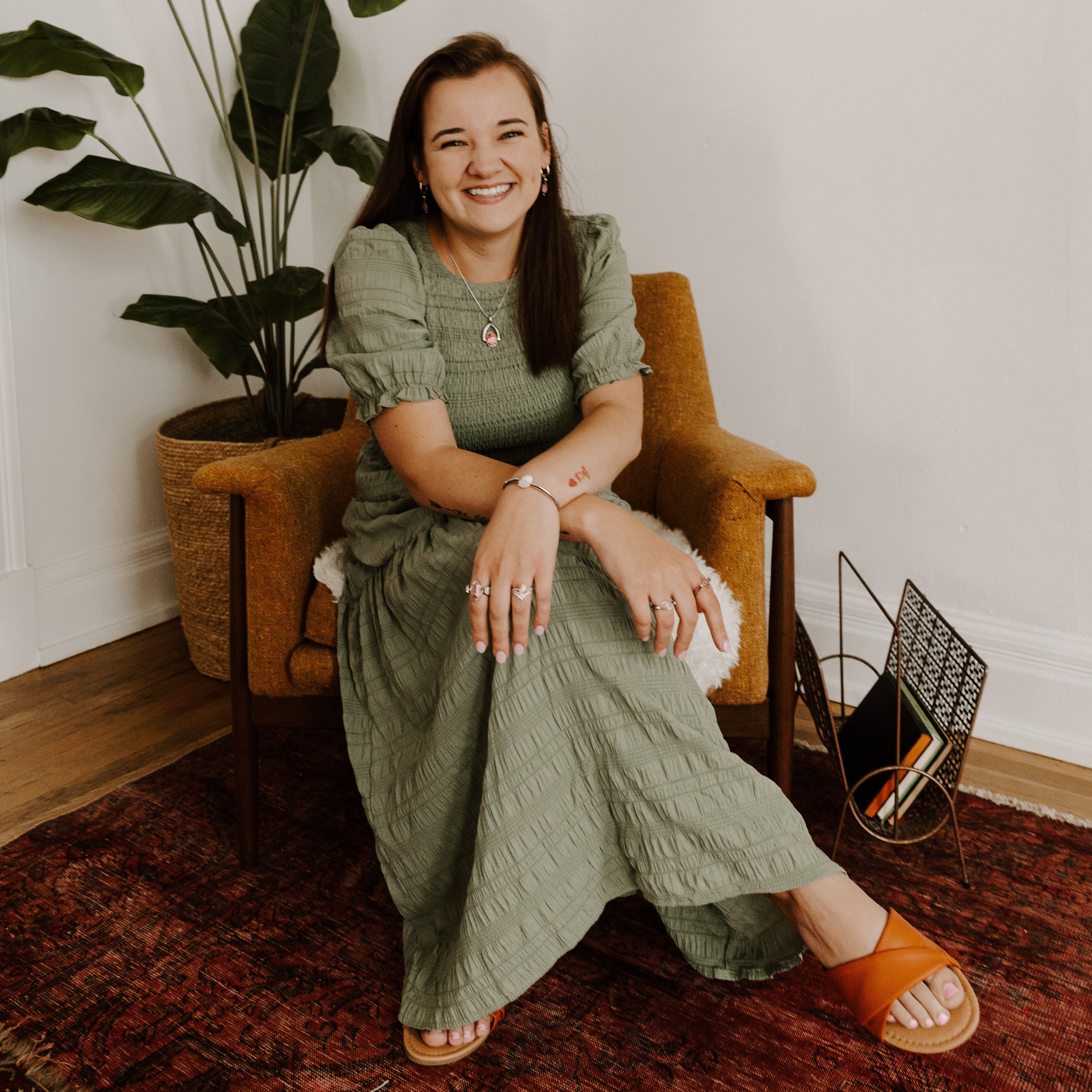 Person modeling on a chair wearing fidget jewelry