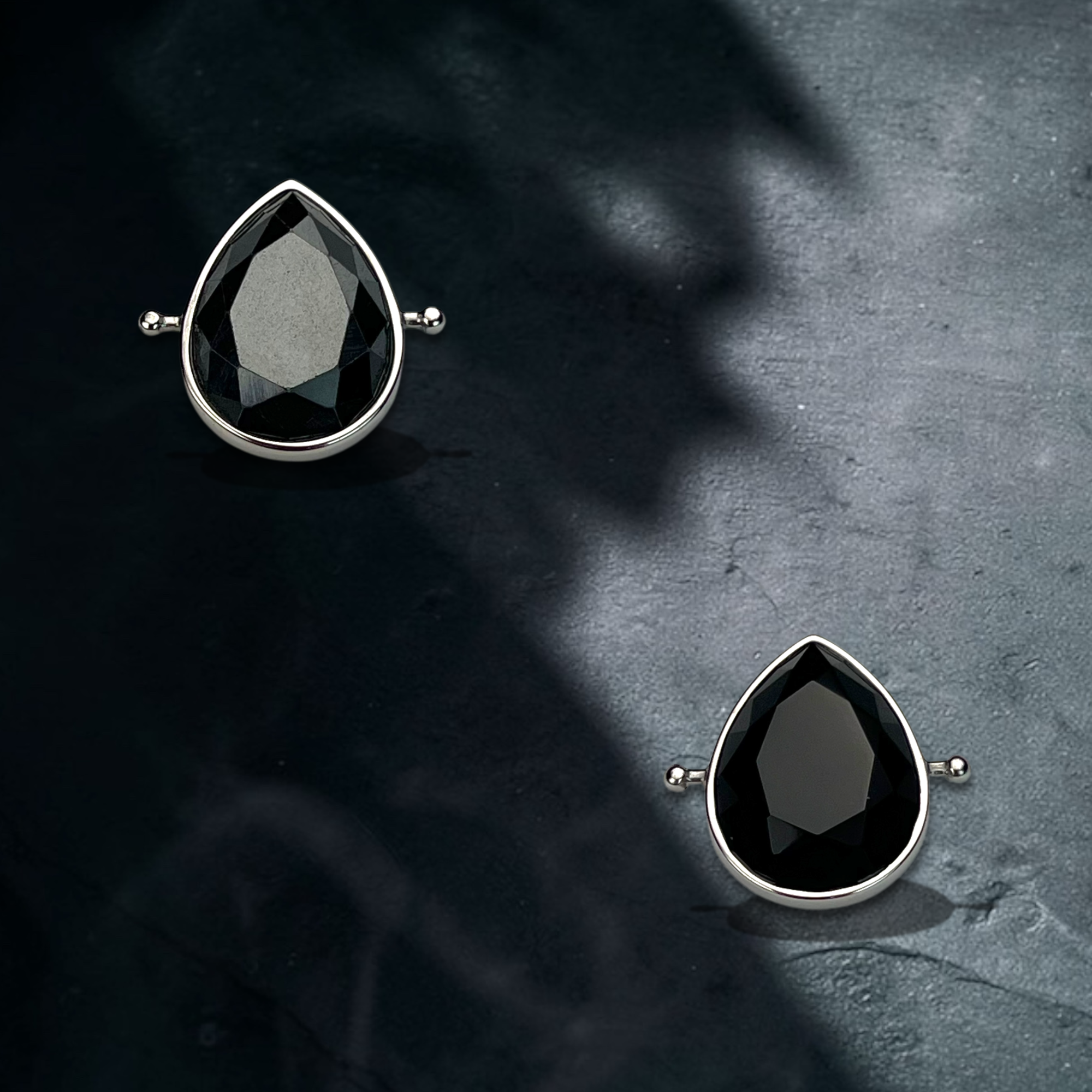 Lifestyle photo showing Hematite and Onyx crystals in AquaPoint™ shape