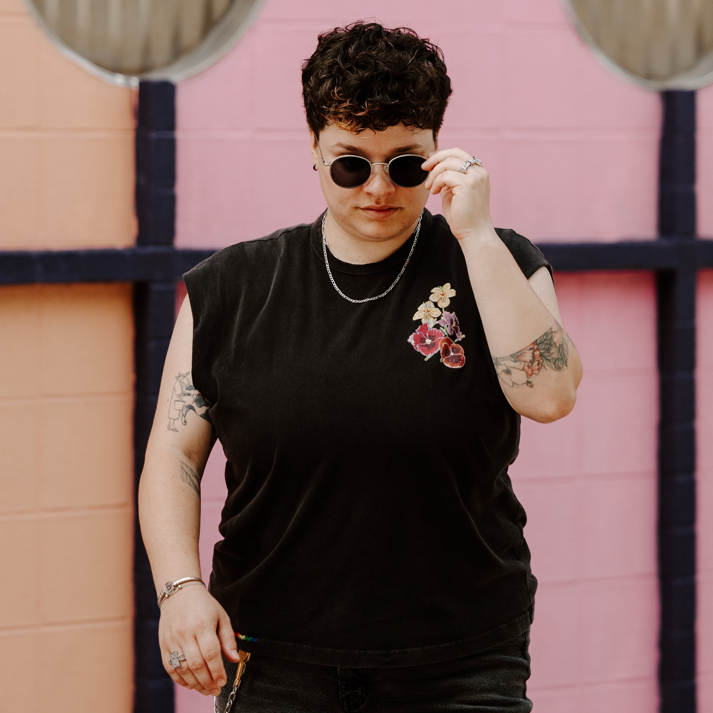 Person posing with sunglasses and fidget jewelry