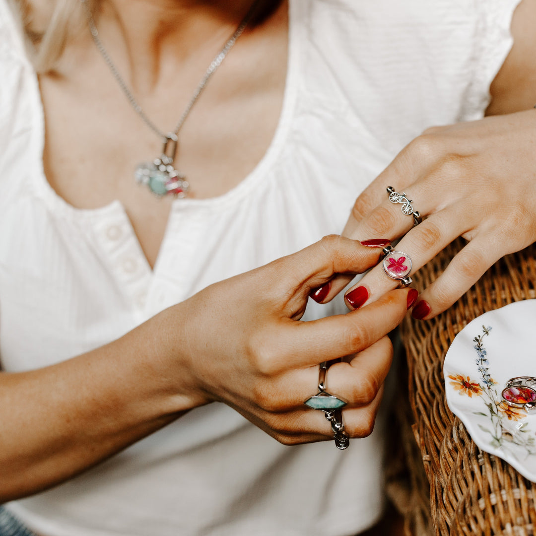Person messing with their fidget ring while modeling other fidget jewelry