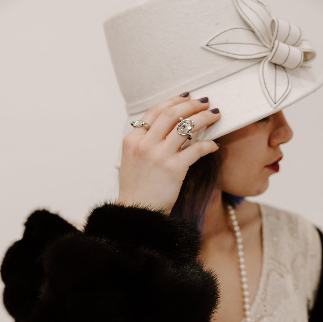 Person wearing a 1920s style outfit with silver fidget rings