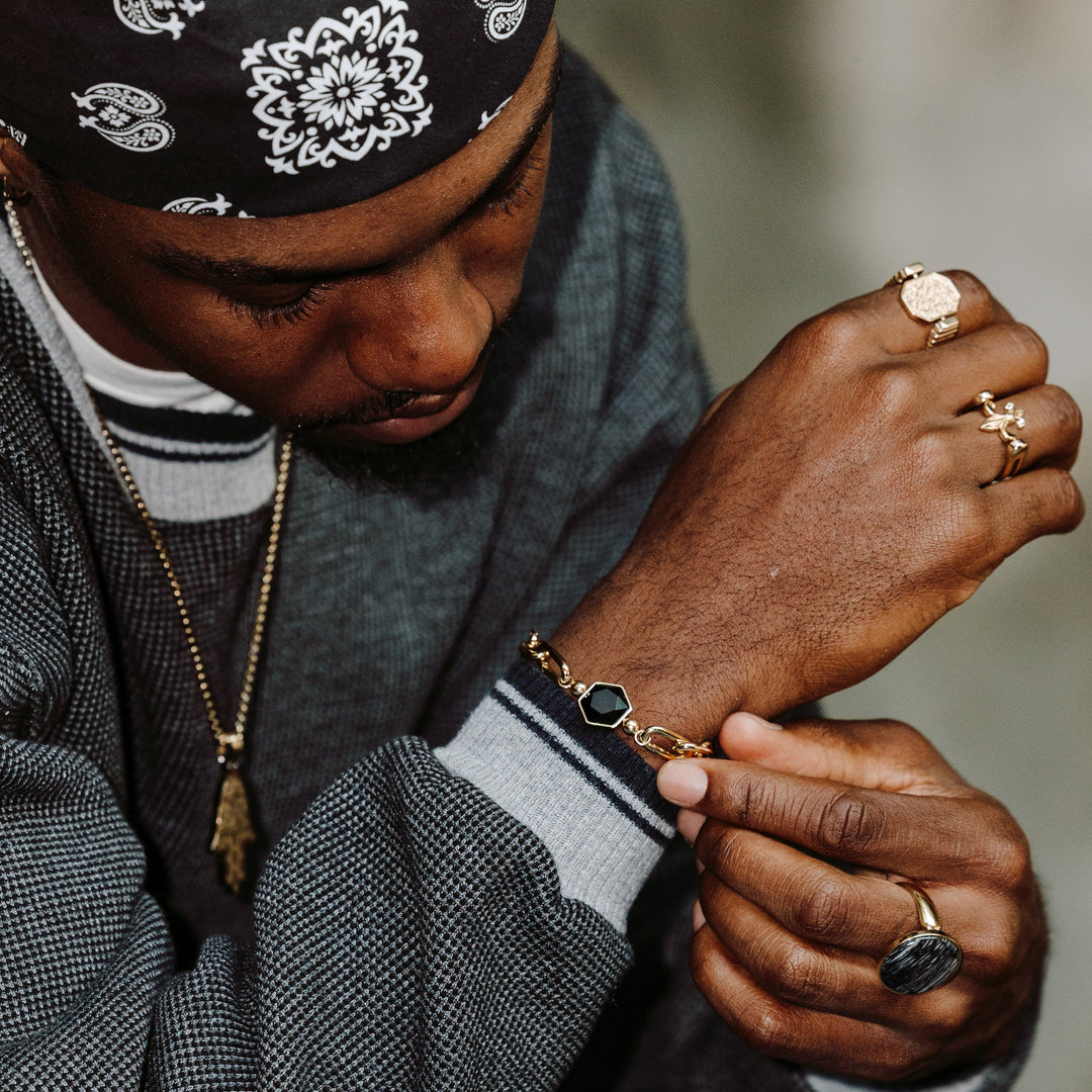 Photograph of person wearing interchangeable rings and bracelet