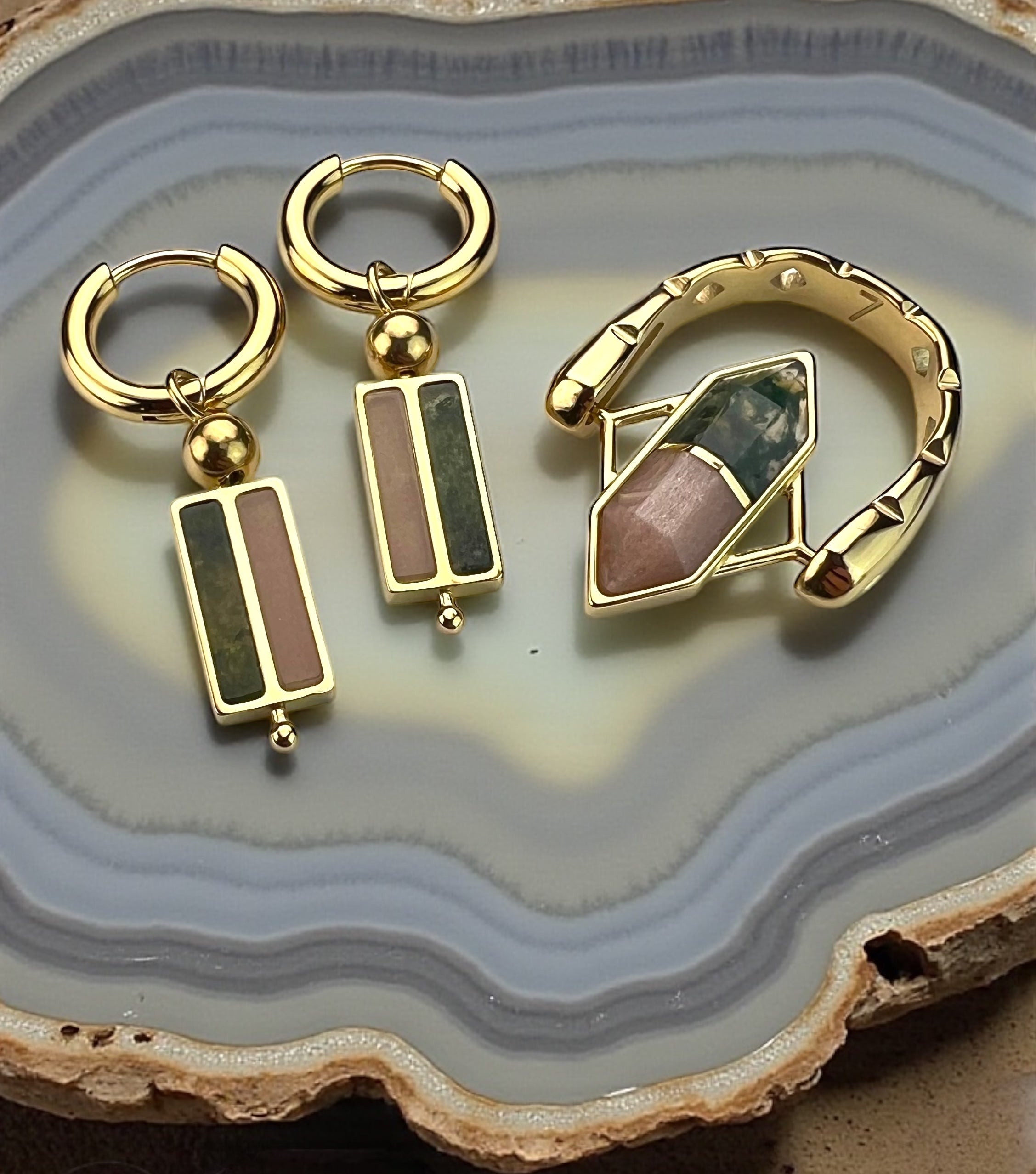 Lifestyle photo of gold Moss Agate and Sunstone Crystal Pairing fidget jewelry