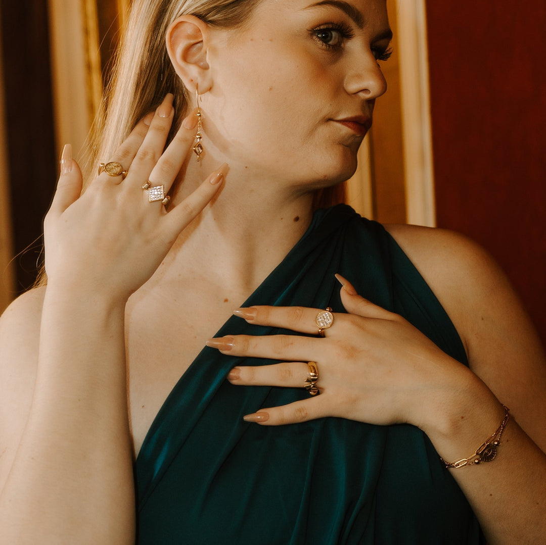 Person posing wearing gold fidget jewelry