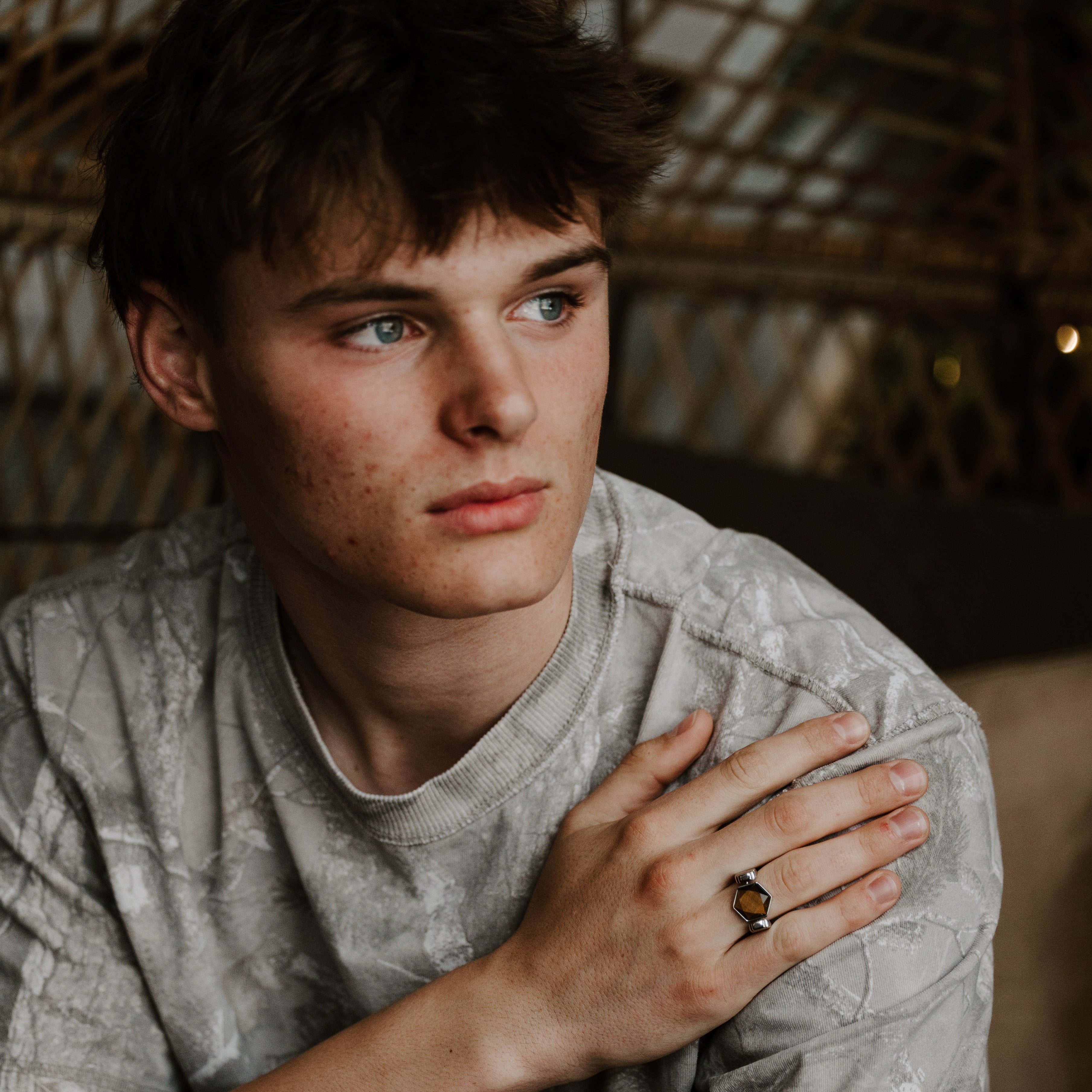 Person looking melancholic wearing a crystal fidget ring