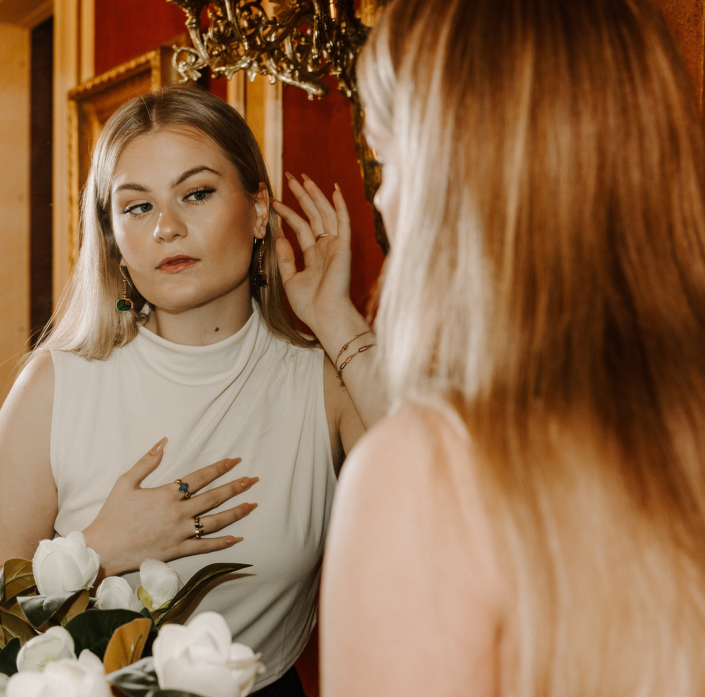 Person looking at themselves in the mirror admiring their fidget jewelry