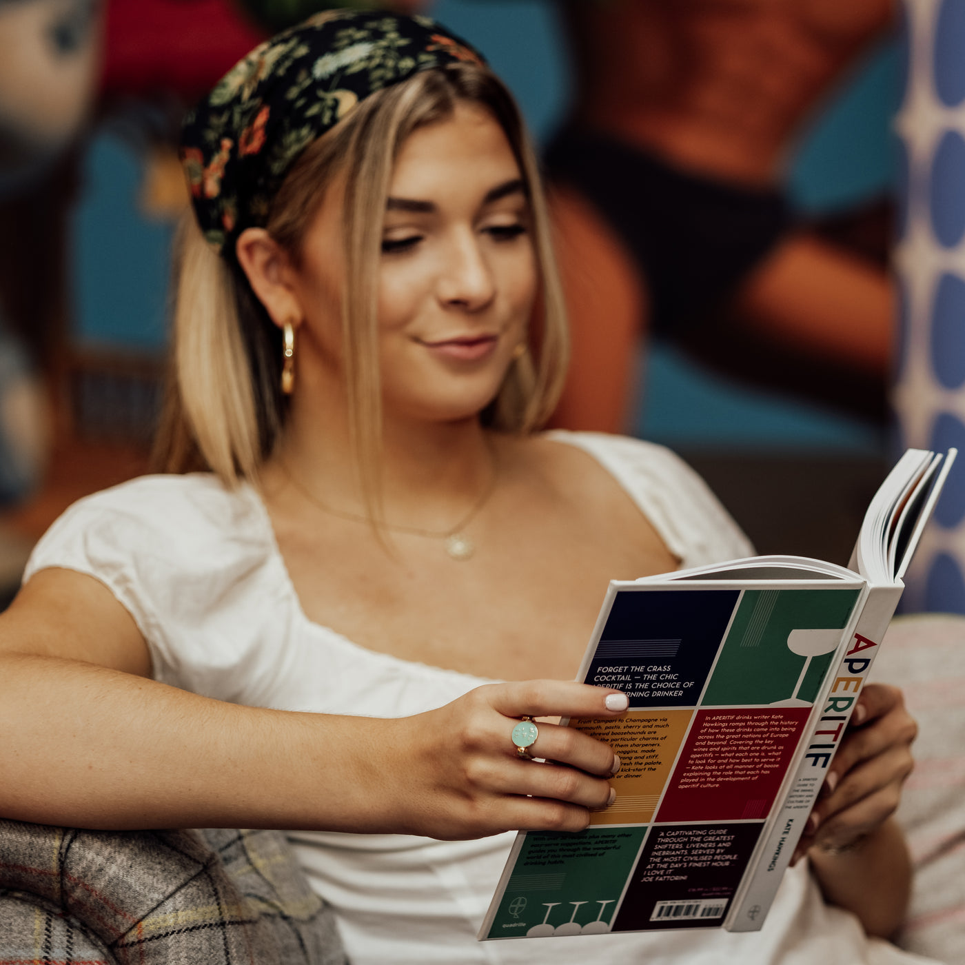 Person reading a book wearing a silver fidget ring