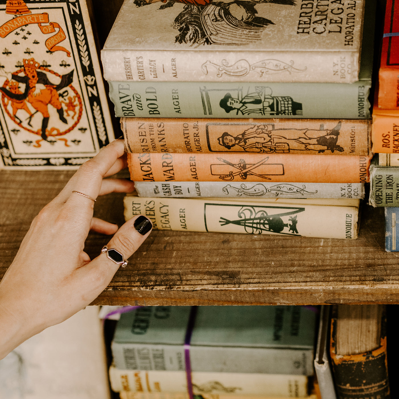 Person Looking at classic books wearing an onyx fidget ring