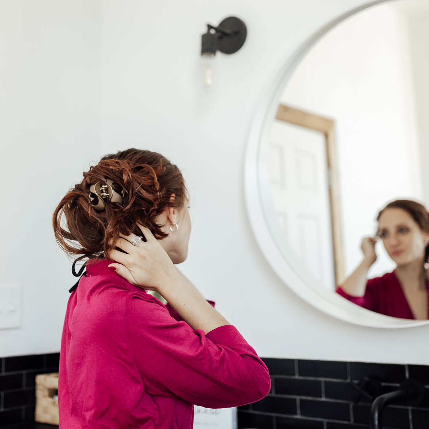 Person wearing robe and looking in mirror wearing silver fidget ring