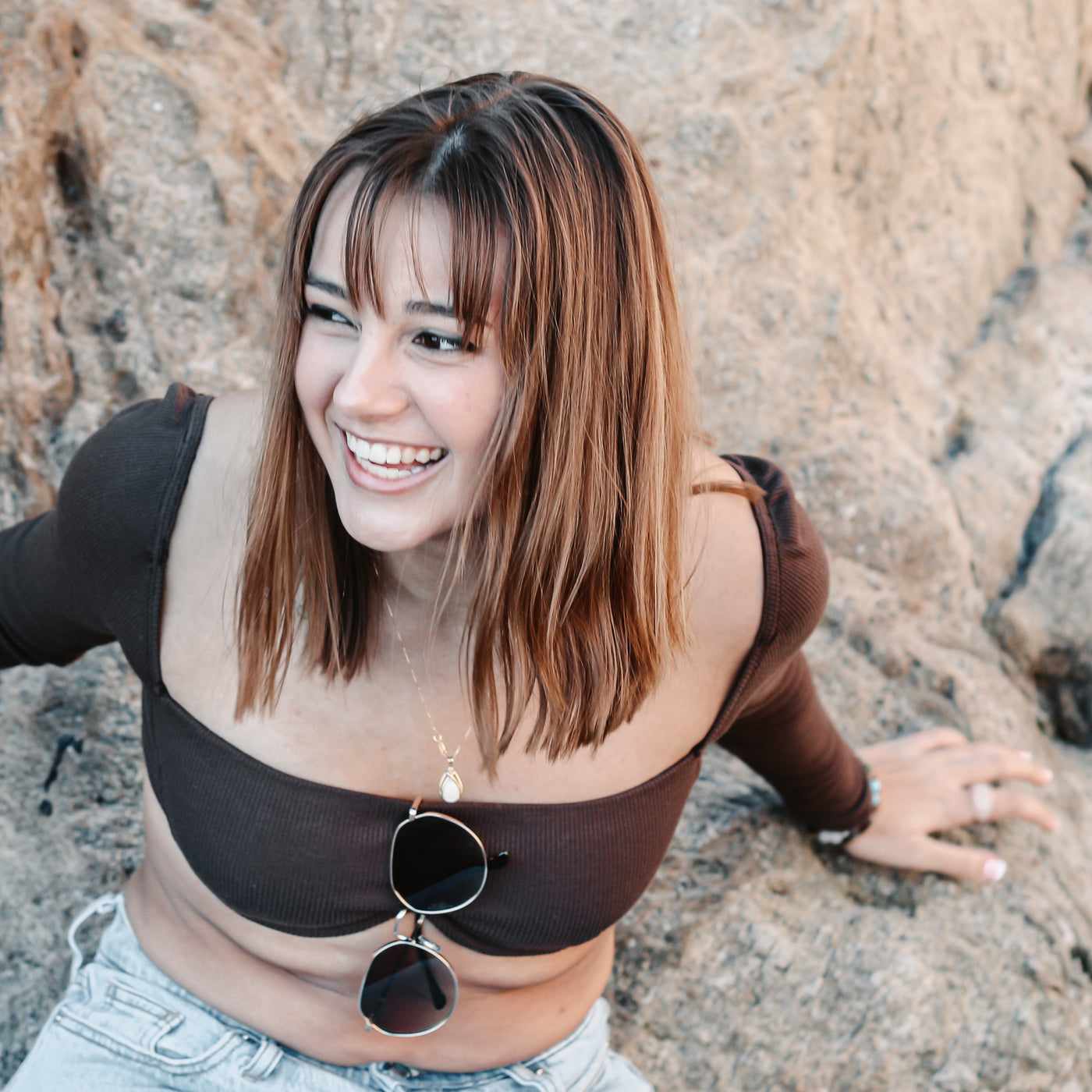 Person smiling in front of rocks wearing silver fidget ring