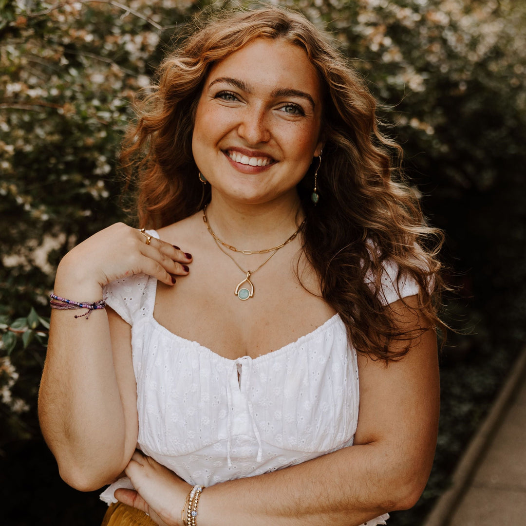 Person posing in front of a tree wearing Sardonyx fidget jewelry