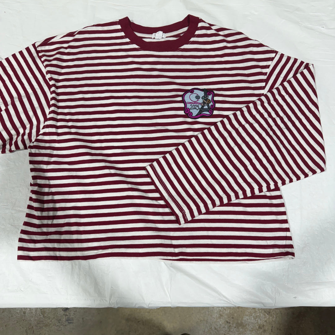 A long-sleeve t-shirt with vertical maroon and white stripes, featuring a CONQUERing Paris 2025 patch on the left chest. One of a kind item - only 1 made!