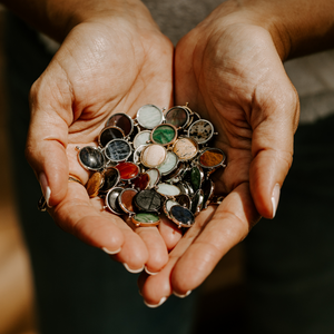 female hands holding a pile of crystal spinners in different colors